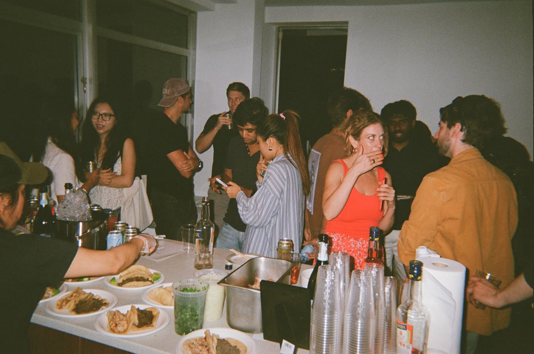 Guests sharing drinks and conversation at Oasis HQ