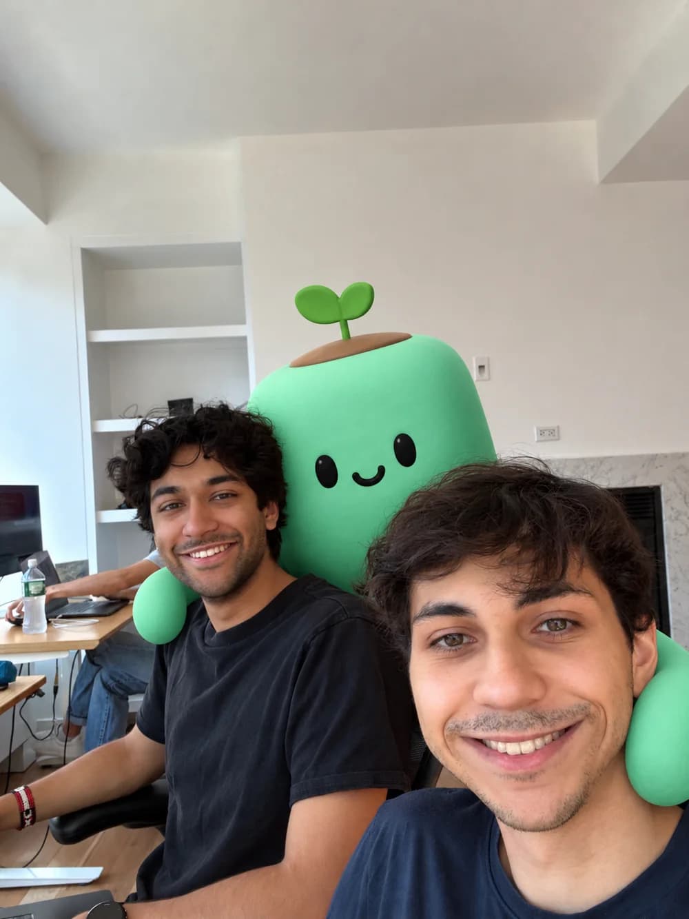 A green sprout agent hugging two founders in the office