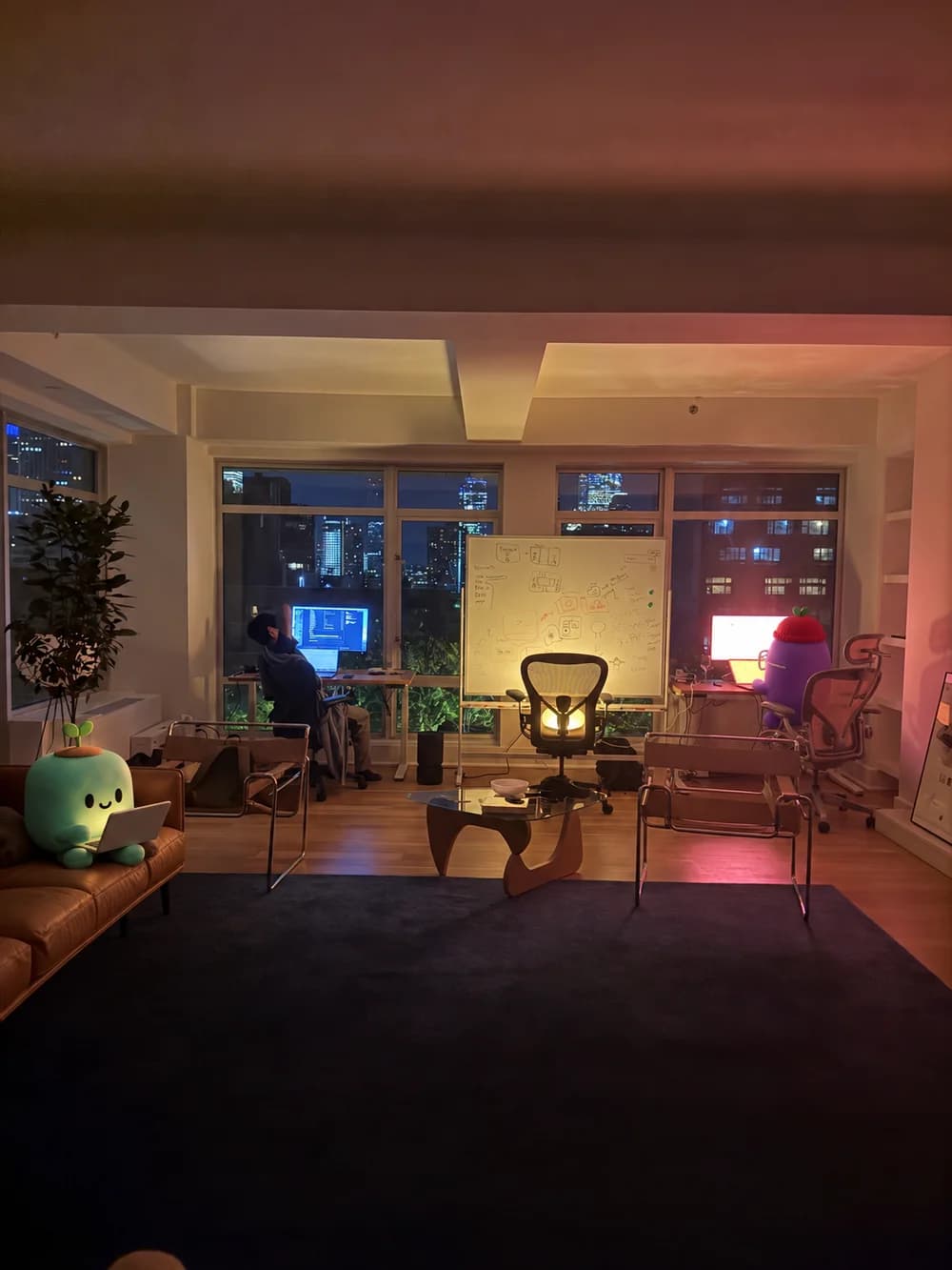 Teammates and agents working late together in a warmly lit office