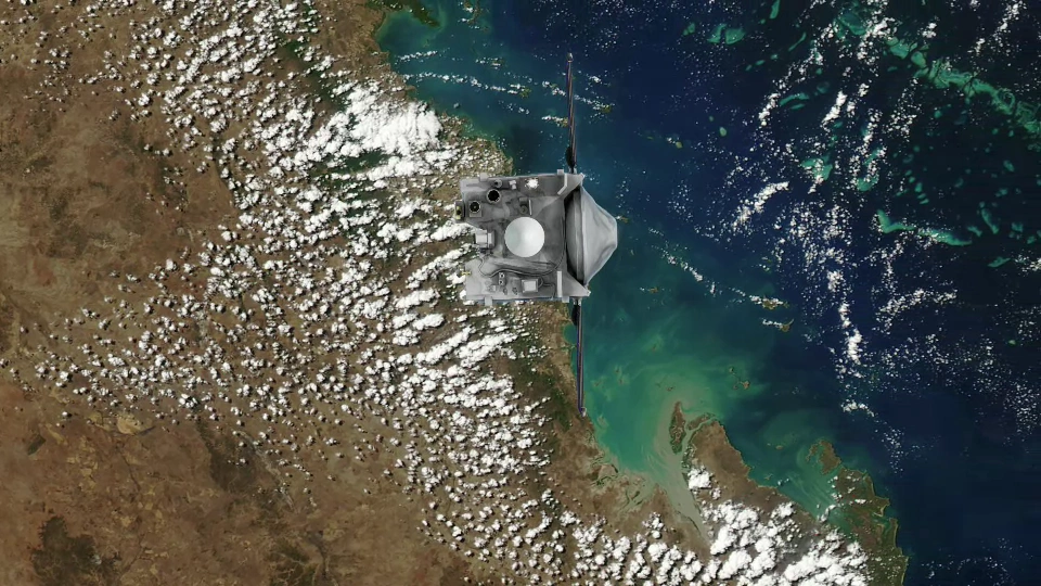 Spacecraft above a coastline with clouds below