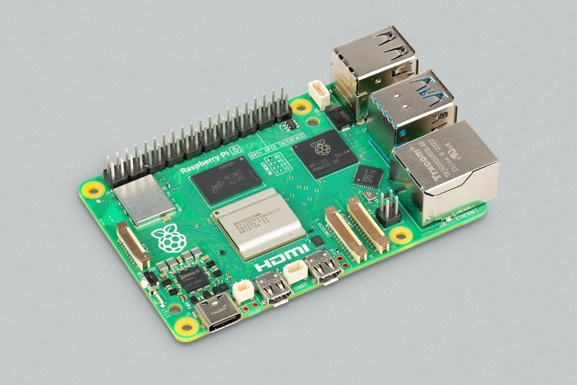Raspberry Pi 4 Model B computer board on a grey background. It features a processor, RAM, HDMI port, USB ports, and Ethernet port.